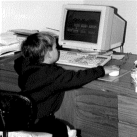A baby Aidan sitting at a desk using an old DOS PC.